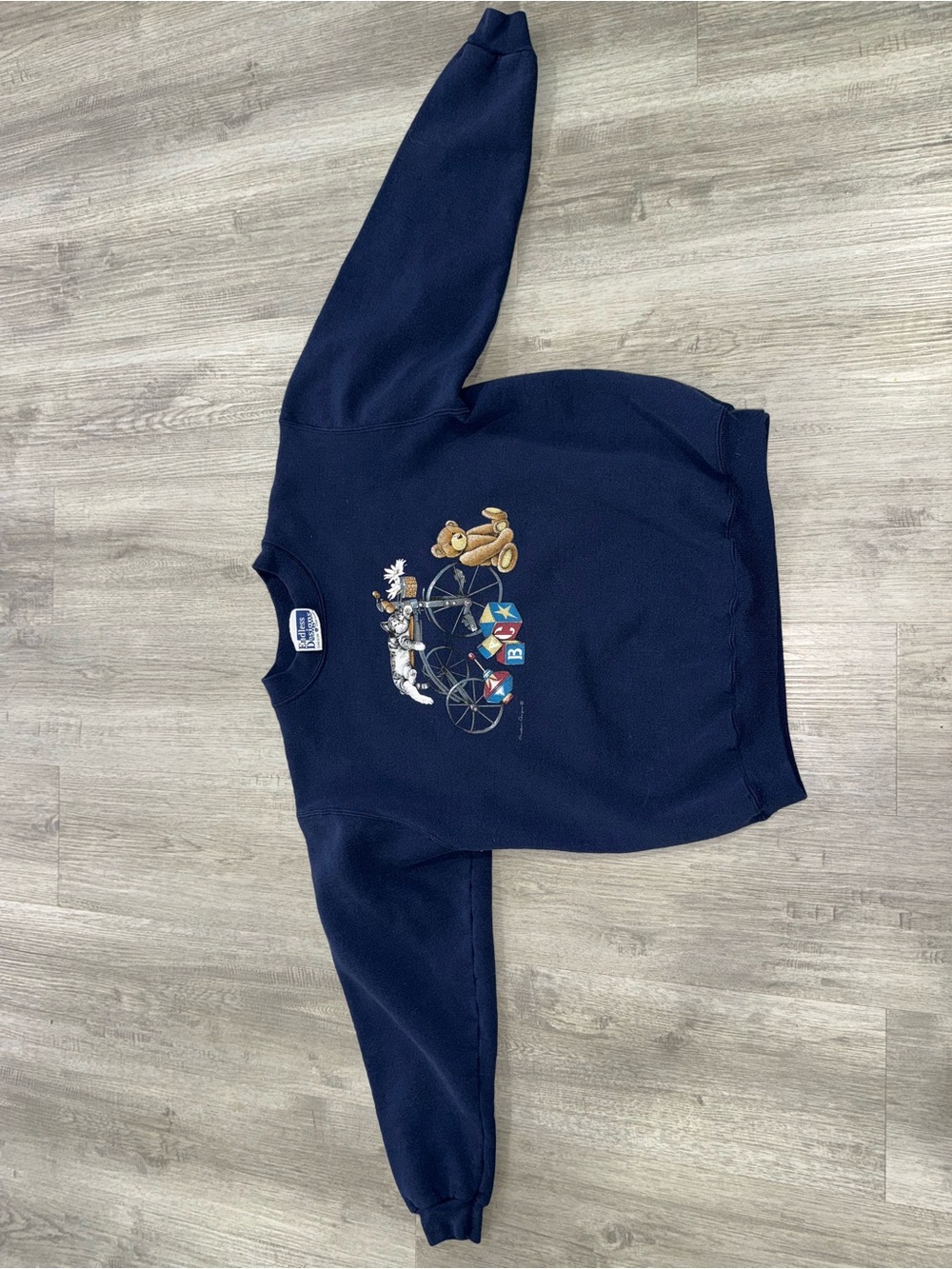 Navy Crewneck Sweater with Playful Toy Bicycle Graphic by